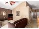 The living room features high ceilings, a ceiling fan, a TV, and comfortable seating on the carpet at 2741 N 137Th Ave, Goodyear, AZ 85395