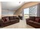 Inviting upstairs loft with a comfortable seating area and a sliding glass door that leads to a balcony at 2741 N 137Th Ave, Goodyear, AZ 85395