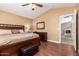 Bedroom features a king bed, dark wood floors, and access to an adjacent room at 2741 N 137Th Ave, Goodyear, AZ 85395