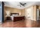 Spacious main bedroom with hard wood floors, view of the ensuite bathroom and backyard at 2741 N 137Th Ave, Goodyear, AZ 85395
