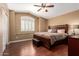 Bedroom with wood floors, a ceiling fan, and a window with a built-in window seat at 2741 N 137Th Ave, Goodyear, AZ 85395