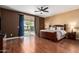 Spacious main bedroom with hard wood floors, view of the backyard and ensuite bathroom entrance at 2741 N 137Th Ave, Goodyear, AZ 85395