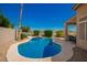 Landscaped backyard with a sparkling pool, spa, and inviting patio seating area, perfect for relaxation at 2741 N 137Th Ave, Goodyear, AZ 85395