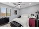 Comfortable bedroom with modern furnishings, a ceiling fan, and natural light at 3535 E Crescent Way, Gilbert, AZ 85298