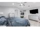 Bright primary bedroom with a ceiling fan, TV, and spacious layout at 3535 E Crescent Way, Gilbert, AZ 85298