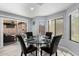 Breakfast nook area with a modern glass table with leather chairs, tile flooring, and natural light at 3535 E Crescent Way, Gilbert, AZ 85298