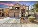 Two-story home featuring a three car garage, arched entryway, neutral color palette, and manicured landscaping at 3535 E Crescent Way, Gilbert, AZ 85298