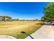 Large community green space with a paved walking path, perfect for outdoor activities and enjoying nature at 3535 E Crescent Way, Gilbert, AZ 85298