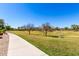 Community green space featuring a paved walking path, grassy lawn, disc golf baskets, and sports goals at 3535 E Crescent Way, Gilbert, AZ 85298