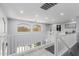 Bright upper hallway with a modern railing that overlooks the living room with large windows at 3535 E Crescent Way, Gilbert, AZ 85298
