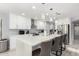 Modern kitchen boasts a large marble island, stainless steel appliances, and ample white cabinetry at 3535 E Crescent Way, Gilbert, AZ 85298