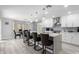 Bright kitchen features a spacious island with seating, sleek white cabinetry, and stylish pendant lighting at 3535 E Crescent Way, Gilbert, AZ 85298