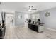 Home office with tile floors, modern ceiling fan, accent mirror and a large desk with black desktop at 3535 E Crescent Way, Gilbert, AZ 85298