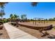 Community playground with swings and gazebo, surrounded by a walking path and lush landscaping at 3535 E Crescent Way, Gilbert, AZ 85298
