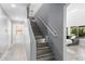Modern staircase with wood-look tile and white banister with views into the living area at 3535 E Crescent Way, Gilbert, AZ 85298