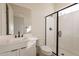 Bathroom featuring vanity with white countertop and walk-in shower with glass doors at 35703 N Geode Way, San Tan Valley, AZ 85144
