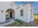 Inviting front entry with an arched porch and manicured landscaping at 35703 N Geode Way, San Tan Valley, AZ 85144