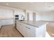 Bright, open kitchen with modern appliances, island, and sleek countertops in a contemporary design at 35703 N Geode Way, San Tan Valley, AZ 85144