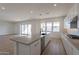 Modern kitchen with large island, stainless steel appliances, and ample natural light from sliding glass doors at 35703 N Geode Way, San Tan Valley, AZ 85144