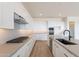Stylish modern kitchen featuring stainless steel appliances, sleek white cabinetry, and a gas cooktop at 35703 N Geode Way, San Tan Valley, AZ 85144