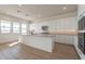 Bright kitchen with a large island, stainless steel appliances, and modern finishes at 35703 N Geode Way, San Tan Valley, AZ 85144
