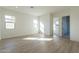 Open living room boasting wood floors, neutral paint, and multiple windows, creating a bright, airy space at 35703 N Geode Way, San Tan Valley, AZ 85144