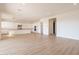 Bright living room open to kitchen and features wood-look flooring and recessed lighting at 35703 N Geode Way, San Tan Valley, AZ 85144