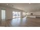 Bright living room that is open to the kitchen and features wood-look flooring and natural light at 35703 N Geode Way, San Tan Valley, AZ 85144