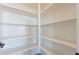 Spacious walk-in pantry featuring white shelving, ideal for storage and organization at 35703 N Geode Way, San Tan Valley, AZ 85144