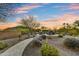 Desert home backyard featuring stone walkways, a firepit with seating, desert landscaping, and desert mountain views at 37170 N Greythorn Cir, Carefree, AZ 85377