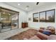 Bedroom featuring sliding glass doors, desert views, area rug, and plush chairs at 37170 N Greythorn Cir, Carefree, AZ 85377