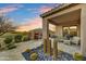 Relaxing covered patio with a fireplace, ample seating, and desert landscaping, ideal for outdoor living at 37170 N Greythorn Cir, Carefree, AZ 85377