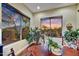 Dining room with desert view windows, plants, a wooden table, and cross back chairs at 37170 N Greythorn Cir, Carefree, AZ 85377