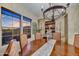 Dining room featuring a wooden table, upholstered chairs, a chandelier, and natural light at 37170 N Greythorn Cir, Carefree, AZ 85377