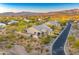 Aerial shot of a home nestled in a desert community, showcasing the home's backyard with desert landscaping at 37170 N Greythorn Cir, Carefree, AZ 85377