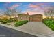 Beautiful single-Gathering home featuring a three-car garage, desert landscaping, and a well-maintained driveway at 37170 N Greythorn Cir, Carefree, AZ 85377