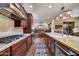 Gourmet kitchen with stainless steel appliances, tile backsplash, breakfast bar, and open floor plan at 37170 N Greythorn Cir, Carefree, AZ 85377