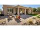 Charming back patio featuring a comfortable seating area and desert landscaping for outdoor relaxation at 3822 E Tracker Trl, Phoenix, AZ 85050