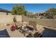 Cozy backyard seating area with comfortable chairs, a decorative table, and desert landscaping at 3822 E Tracker Trl, Phoenix, AZ 85050