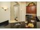Bar area with dark countertops, storage cabinets, decorative lighting, and a sink at 3822 E Tracker Trl, Phoenix, AZ 85050