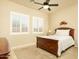 Cozy bedroom with a bed, ceiling fan, carpet flooring, and plantation shutters at 3822 E Tracker Trl, Phoenix, AZ 85050