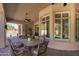 Inviting covered patio with an outdoor dining set and seating, perfect for relaxing and entertaining guests at 3822 E Tracker Trl, Phoenix, AZ 85050