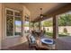 Spacious covered patio with an outdoor seating area, fire pit, and manicured lawn for outdoor enjoyment at 3822 E Tracker Trl, Phoenix, AZ 85050