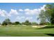 Scenic golf course featuring lush green fairways and sand traps under a bright blue sky at 3822 E Tracker Trl, Phoenix, AZ 85050
