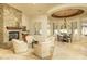 Comfortable living space with a stone fireplace and dining area, perfect for relaxing or entertaining guests at 3822 E Tracker Trl, Phoenix, AZ 85050
