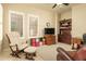 Comfortable sitting area with a plush chair, ottoman, and an entertainment center with a TV and shelves at 3822 E Tracker Trl, Phoenix, AZ 85050