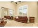 Cozy living room with neutral carpet, comfortable furniture, and bright natural light from the window at 3822 E Tracker Trl, Phoenix, AZ 85050