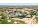 Aerial view of a resort featuring pools, lush landscaping, and a golf course at 3822 E Tracker Trl, Phoenix, AZ 85050