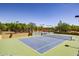 Well-maintained tennis court surrounded by desert landscaping in the Aviano community at 3822 E Tracker Trl, Phoenix, AZ 85050