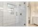 Modern bathroom with tiled shower, glass door, updated showerhead, and decorative tile work at 3861 S Acacia Ct, Chandler, AZ 85248